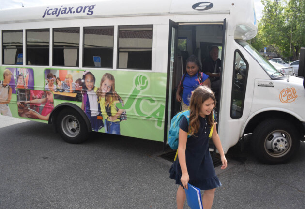 Kids walking off of the JCA bus.