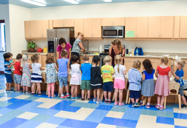 Young children learning how to cook.