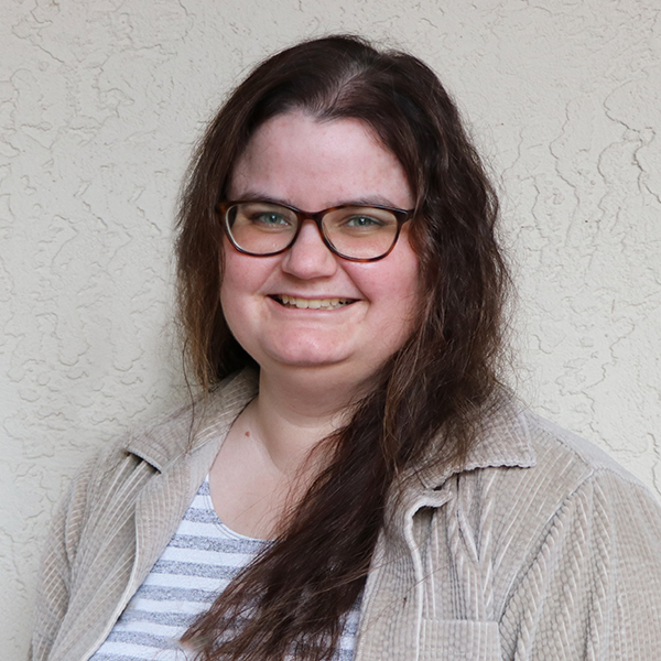 A woman wearing glasses and a striped shirt.