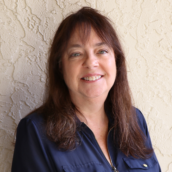 A woman wearing a blue shirt.