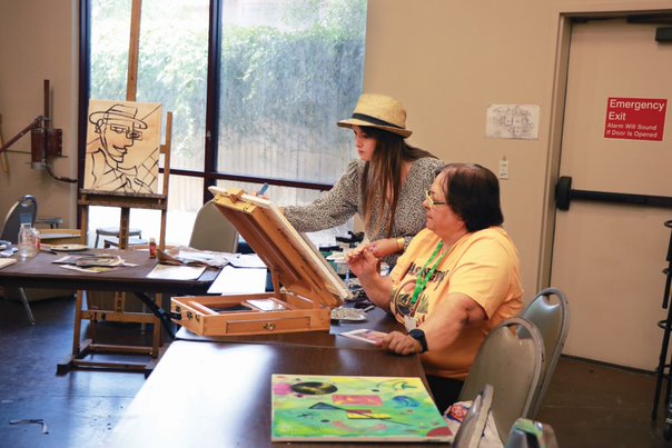 two people painting.