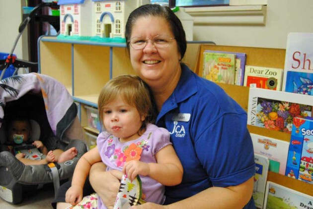 caretaker holding toddler.