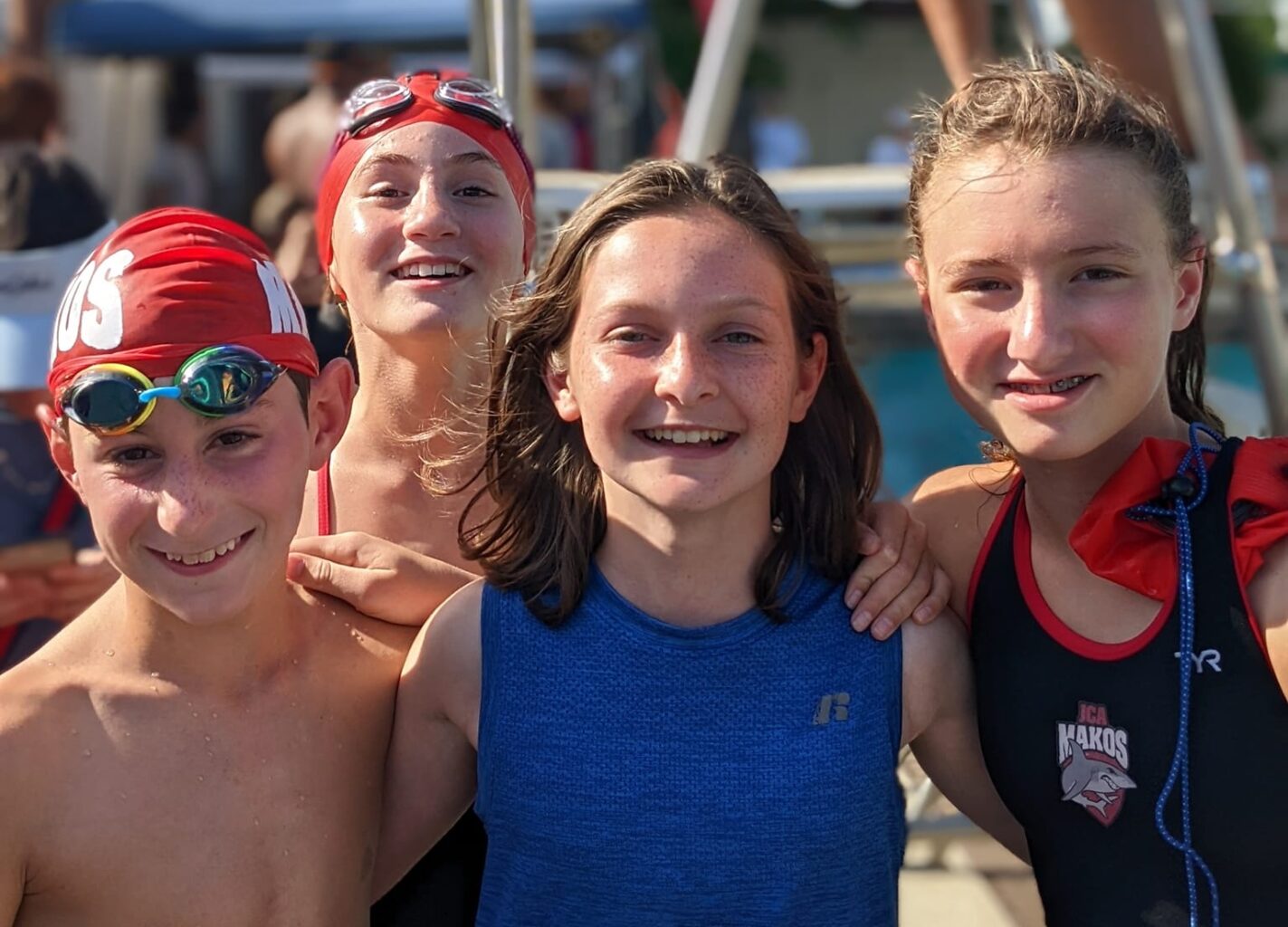 Group of youth Makos Swim Team swimmers smiling