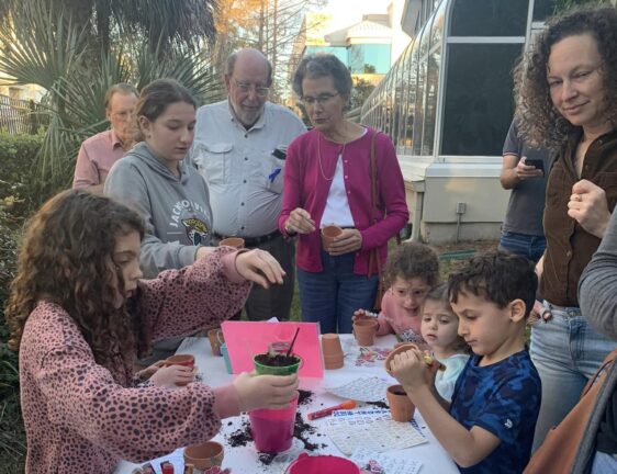 A group of people gather to celebrate at our Tu B’Shevat Mix & Mingle