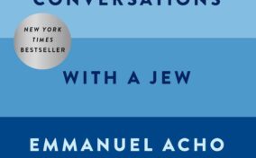 Book cover with horizontal blue stripes showing the title "Uncomfortable Conversations with a Jew" by Emmanuel Acho and Noa Tishby, with a New York Times Bestseller badge.