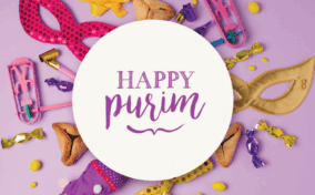 Purim decorations with masks, noisemakers, candies, and hamantaschen pastries arranged around a circular sign that reads 'Happy Purim' on a purple background.