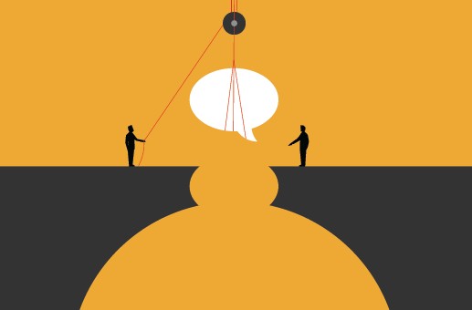 Two people stand on opposite sides of a gap, using ropes and a pulley to lift a large speech bubble between them, symbolizing communication or bridging a divide.